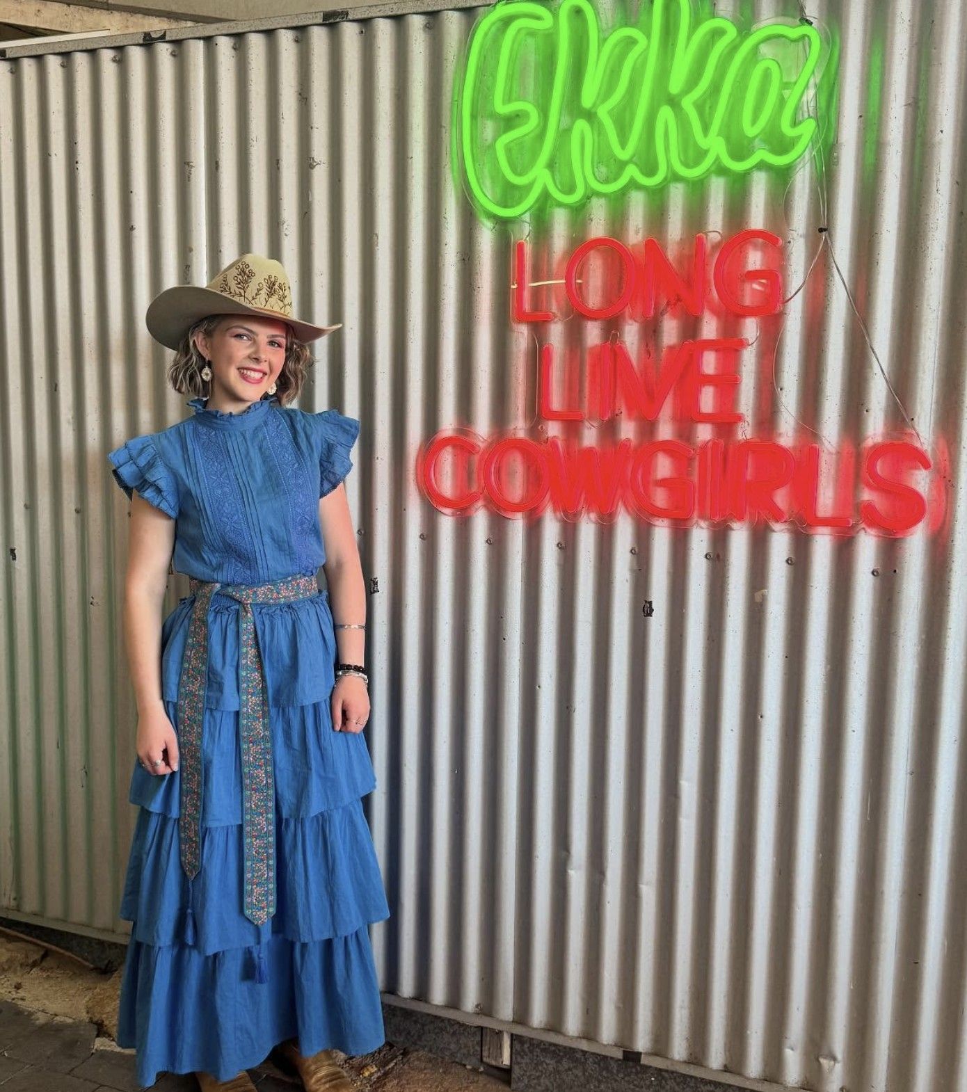 Ruby Holden against corrugated wall